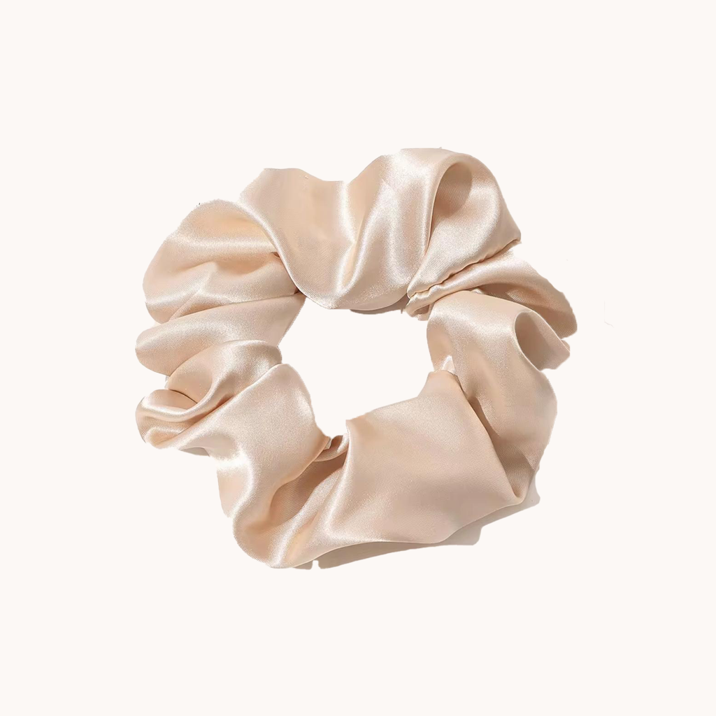 Beige satin scrunchie on a white background