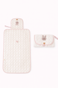 A bunny themed light pink colored diaper changing pad for babies