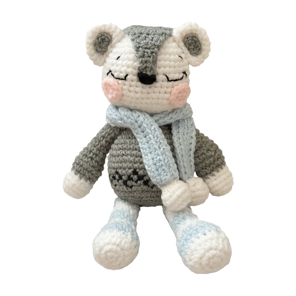 Crocheted mouse toy with a sweater and scarf on a white background