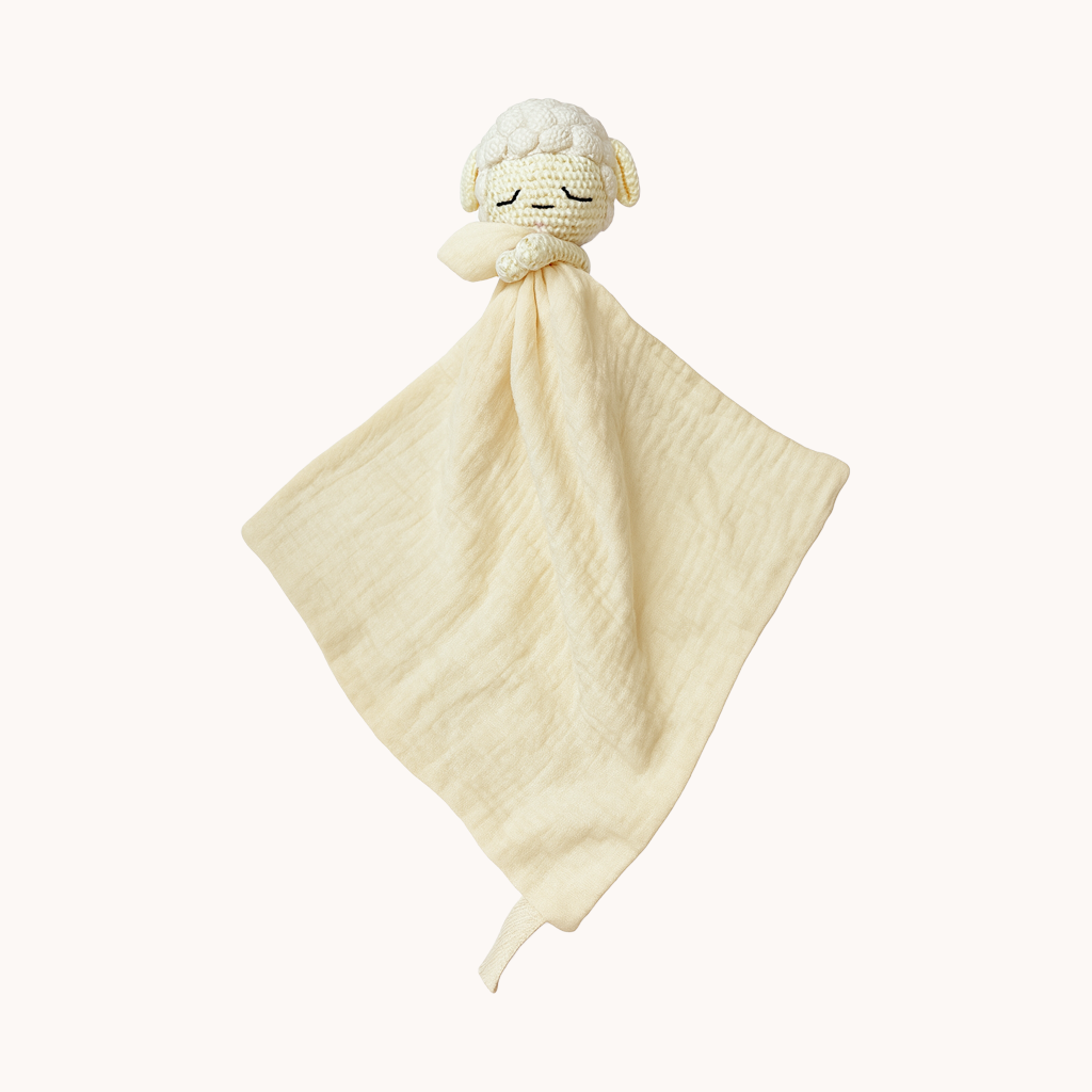 White plush lamb toy with a matching blanket on a white background