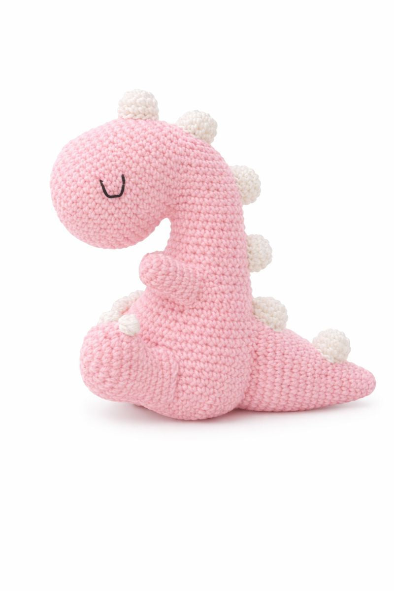 Pink crochet dinosaur toy on a white background